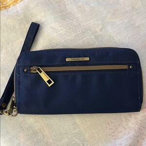 Travelon navy blue anti-theft travel wallet made of durable synthetic fabric.